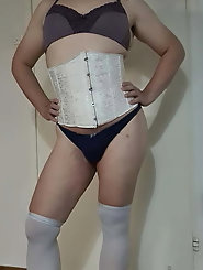 Smiling shemale harlot is taking off her underwear for a photoshoot